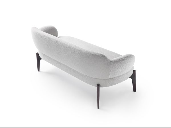 armchair, supported by sleek, sculpted legs.