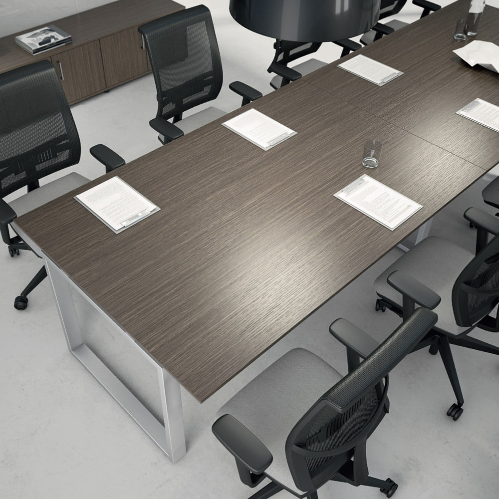 The meeting room features a contemporary table with a wooden top that can accommodate up to 10 people