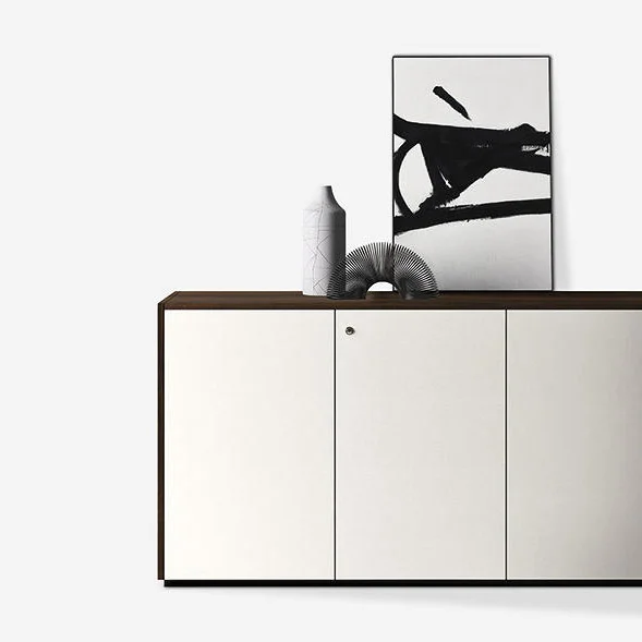 A Middle height cabinet with dark wood sides and white color shutters
