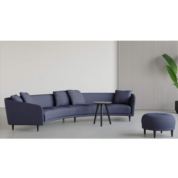 blue curved sofa and pouf