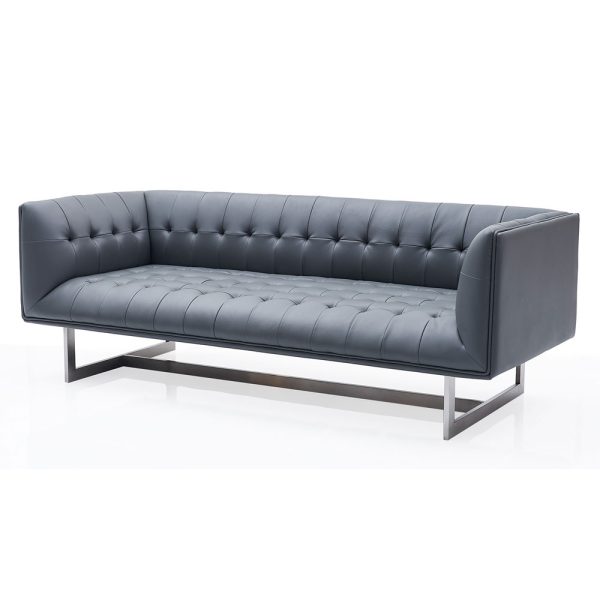 elegant capitone sofa, boasting a low back and elevated by modern metal legs.